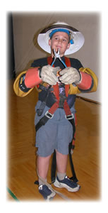 At WFEC’s Member Appreciation Day/Annual Meeting, eight-year-old Steven Varnum, son of WFEC Electrical Engineer Keith Varnum and his wife, Melissa, tries on
Co-op linemen’s gear.